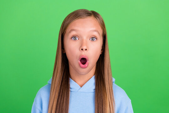 Close up photo of funky little girl impressed big sales huge prices dressed stylish blue sweatshirt isolated on green color background