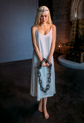 portrait fantasy woman princess hands in chains prison handcuffs steel chain shackles. White...