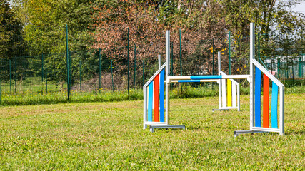 Area equipped for dog training. Dog training in a fenced area..Obstacle courses with tunnels, steep ramp, slides, poles and high jump.