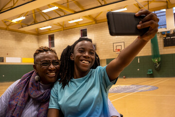 Teenage girl taking selfie with grandmother