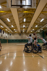 Men in wheelchairs playing basketball