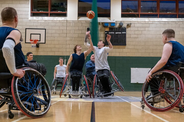 Fototapeta na wymiar Men in wheelchairs playing basketball