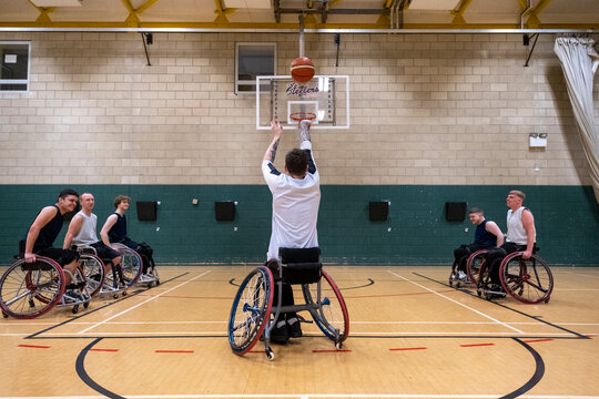 Man in wheelchair doing free throw during match
