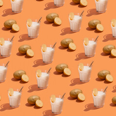 pattern of milk glass and potato on beige background, creative minimalism and healthy food concept