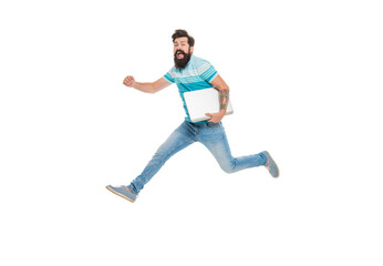Energetic student midair isolated on white. Happy student jumping with laptop. Bearded man student