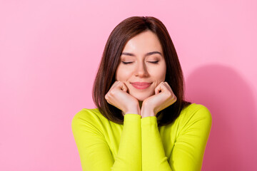 Fototapeta Photo of cute dreamy lady wear yellow top empty space arms cheeks chin closed eyes isolated pink color background obraz