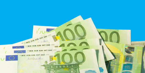 Banknotes of 100 euros on a blue background