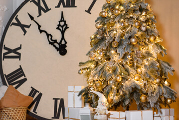 Christmas Card with Beautiful Snowy Christmas Tree and Golden Toys, Garland and Big Clock.