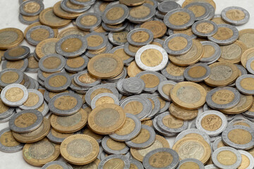group of mexican peso coins of various denominations, with copy space