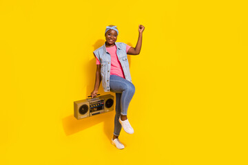Fototapeta Full size portrait of plus size figure girl hold boombox raise fist up triumph isolated on yellow color background obraz