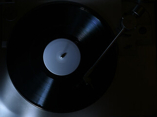 rim light on turntable in blue light playing vinyl record