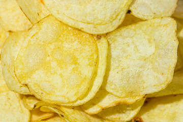Background from potato chips. A delicious way to cook potatoes. Delicious fast food