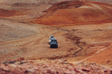 Travel offroad with car 4x4 mountains Altai Mars valley or red sand Gobbi Mongolia © Parilov