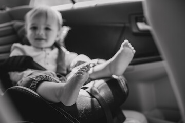 bare feet baby sitting car seat back