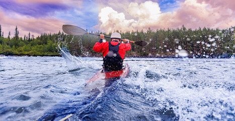 Sport Man is kayaking with spray paddle splashes. Summer day, travel concept