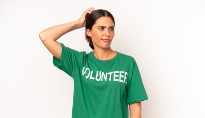 pretty hispanic woman smiling happily and daydreaming or doubting. ecology and volunteer concept