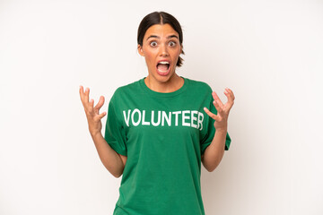 pretty hispanic woman amazed, shocked and astonished with an unbelievable surprise. ecology and...
