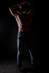 Fototapeta na wymiar Young bodybuider posing in studio