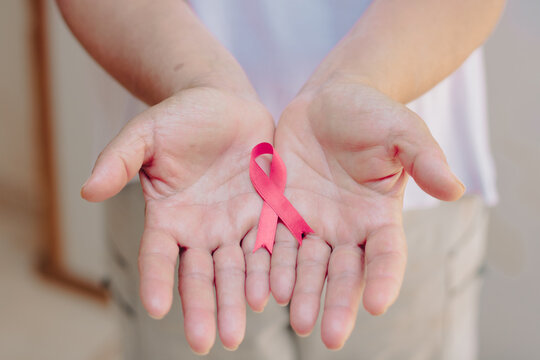 Breast Cancer Awareness Month image.  Mature White Woman With pink ribbon isolated.