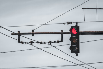 Traffic semaphore with red light for cars to stop in the intersection shot from below