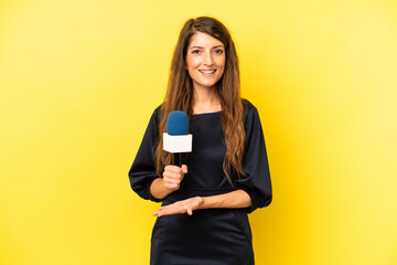 pretty caucasian woman smiling cheerfully, feeling happy and showing a concept. tv presenter concept