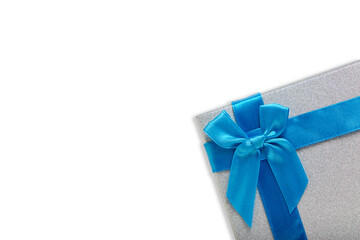 Gift box white background is tied with blue ribbon with bow.