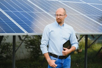 Engineer at solar power station with solar panel. Practical lessons on renewable energy power...