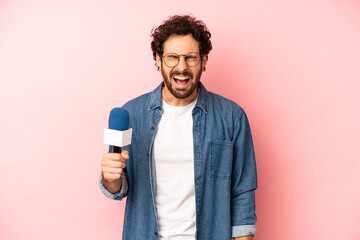 crazy bearded man shouting aggressively, looking very angry. presenter with a microphone concept