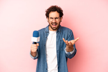 crazy bearded man looking angry, annoyed and frustrated. presenter with a microphone concept