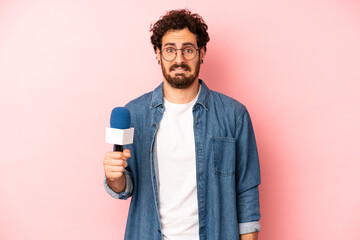 crazy bearded man looking puzzled and confused. presenter with a microphone concept