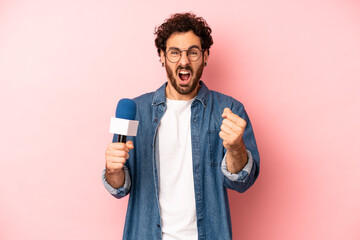 crazy bearded man shouting aggressively with an angry expression. presenter with a microphone...