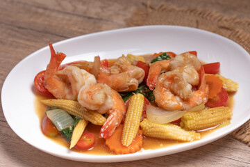 Stir-fried mixed vegetables with shrimp. In a white plate, healthy food concept.