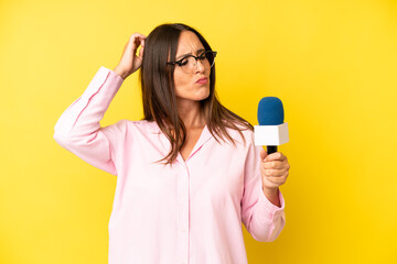 hispanic young adult woman feeling puzzled and confused, scratching head. interviewer with a...
