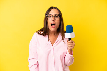 hispanic young adult woman looking very shocked or surprised. interviewer with a microphone