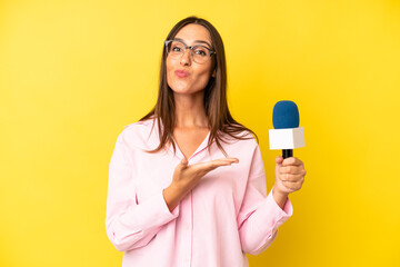 hispanic young adult woman smiling cheerfully, feeling happy and showing a concept. interviewer...