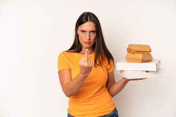 hispanic young adult woman feeling angry, annoyed, rebellious and aggressive. fast food concept