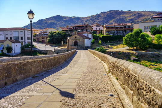 Stone path over a medieval Romanesque bridge to the old houses of the Barco de Avila, Spain.