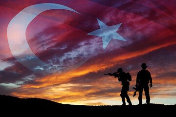 Fototapeta na wymiar Silhouettes of soldiers on a background of Turkey flag and the sunset or the sunrise. Concept of crisis of war and conflicts between nations. Greeting card for Turkish Armed Forces Day, Victory Day.