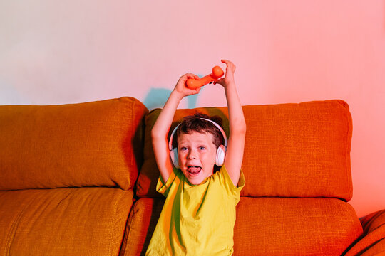 Cheerful boy celebrating victory while playing video game