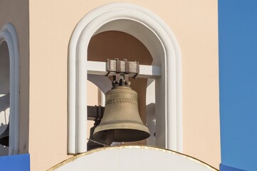 Fototapeta premium Big iron copper or lettuce churh bell hanging in arch