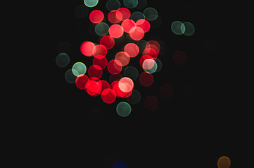 Coloured bokeh of firework in darkness