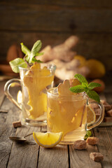 Ginger tea with ingredients on an old wooden table.