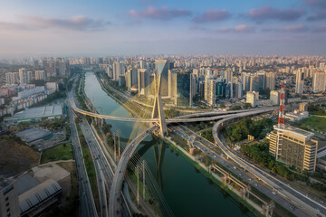 Fototapeta na wymiar Aerial view of Octavio Frias de Oliveira Bridge (Ponte Estaiada) over Pinheiros River at sunset - Sao Paulo, Brazil