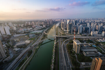 Fototapeta na wymiar Aerial view of Octavio Frias de Oliveira Bridge (Ponte Estaiada) over Pinheiros River at sunset - Sao Paulo, Brazil