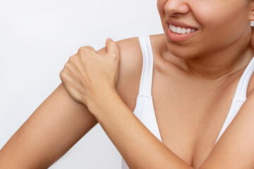Shoulder injuries. Cropped shot of a young caucasian tanned woman holding a shoulder in her hand...