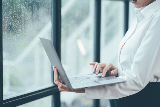 Businessman working at office with documents and graphs, financial information and laptop computer.