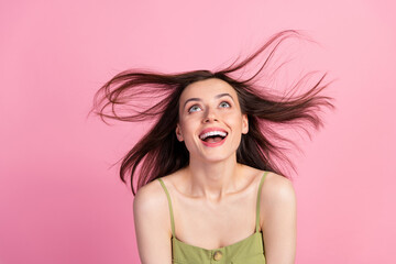 Portrait of attractive cute shine cheerful girl wear khaki tank having fun throwing hair copy space isolated on pink color background