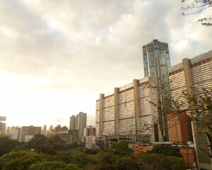 Fototapeta na wymiar Sunrise landscape with tall rectangular building and tower