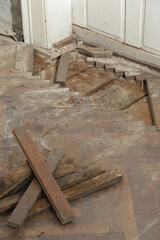 Home improvement. Removing old wooden parquet flooring using crowbar tool. Old wooden floor renovation.