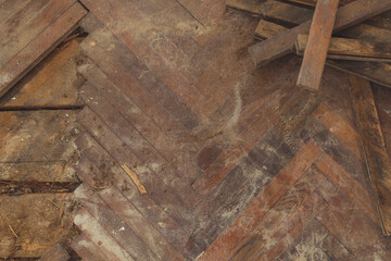 Home improvement. Removing old wooden parquet flooring using crowbar tool. Old wooden floor renovation.